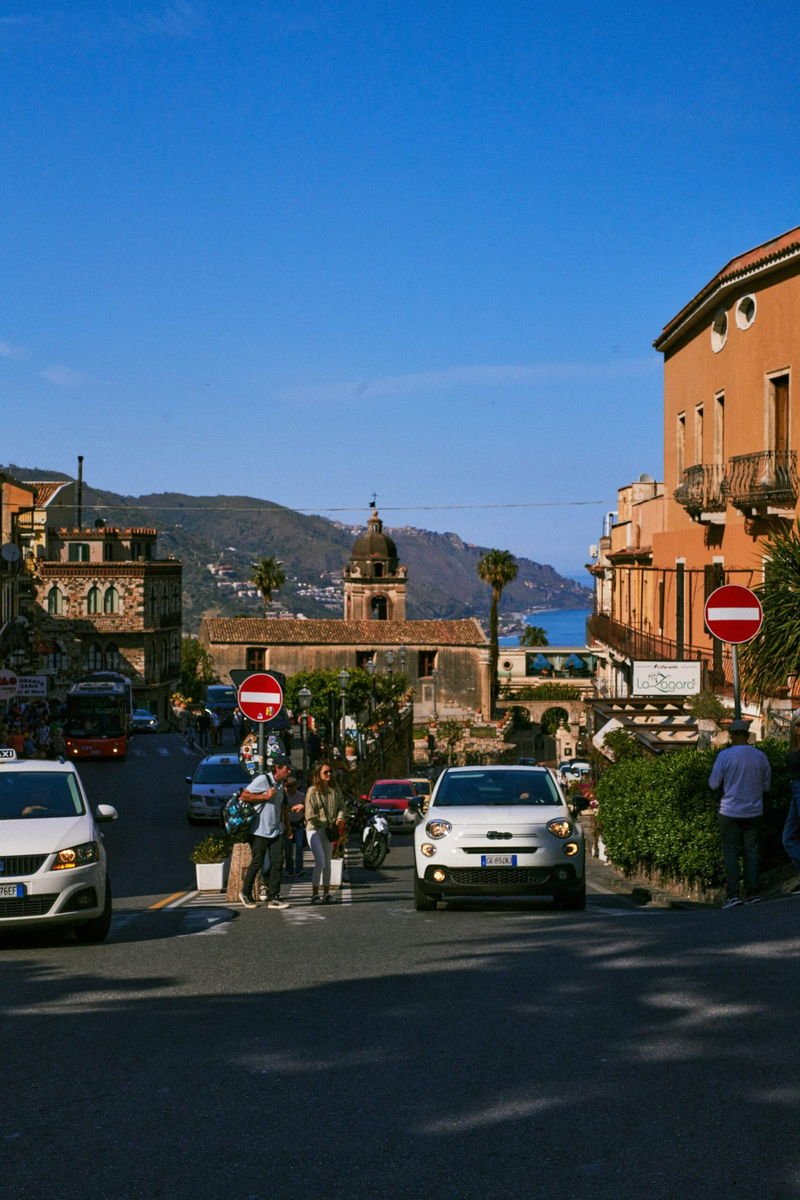 Taormina rooftops and the Ionian Sea at the end of the street