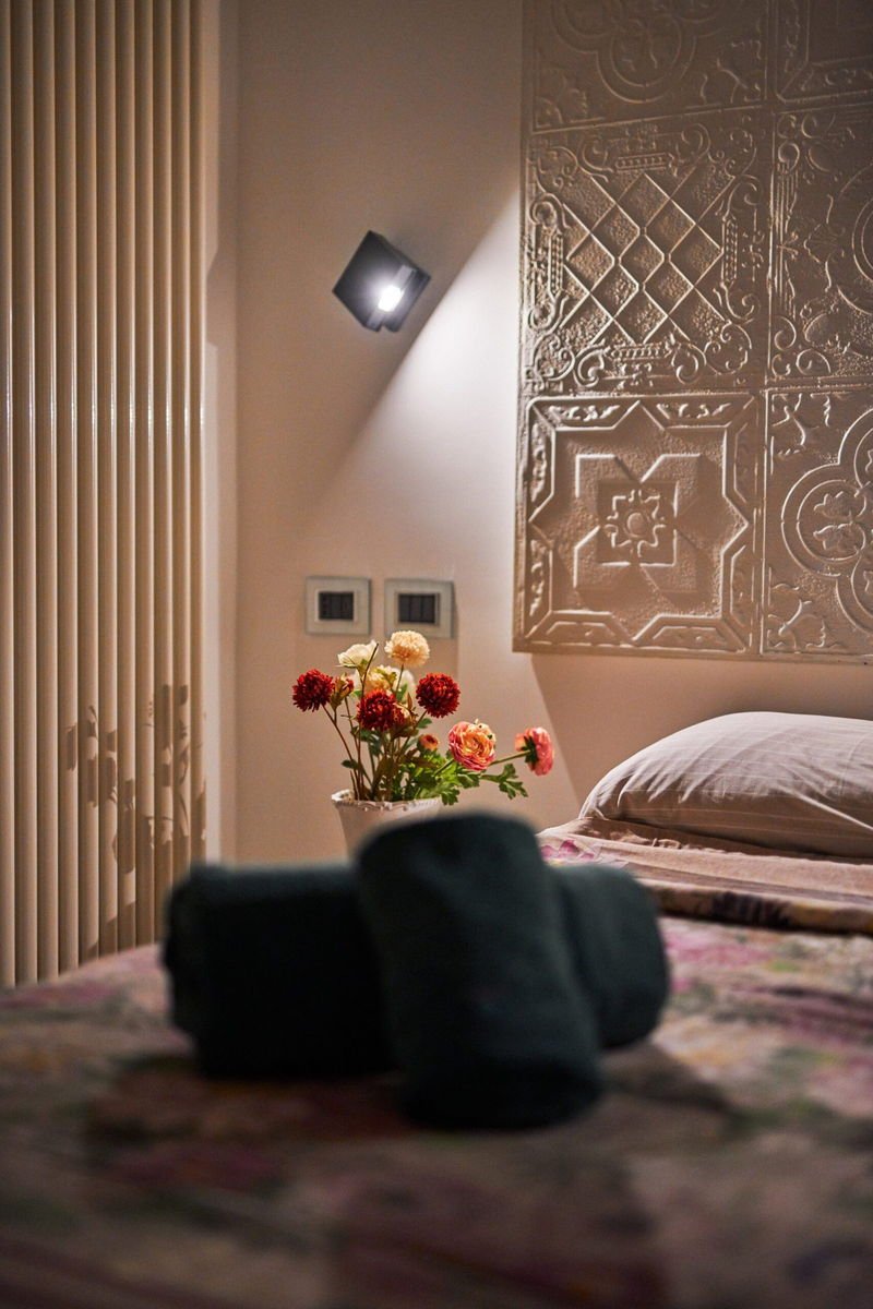 A guest room at the Corvaja Inn, arranged with soft linens and fresh flowers